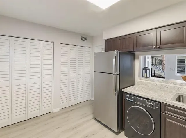 a utility room with cabinets washer and dryer