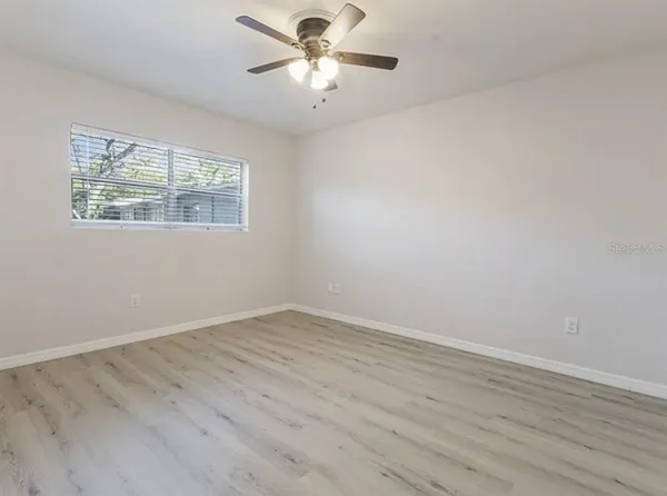 wooden floor in an empty room with a window