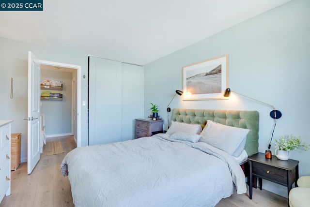 a bedroom with a bed and a potted plant