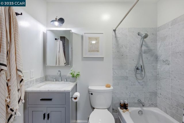 a bathroom with a sink toilet tub and shower