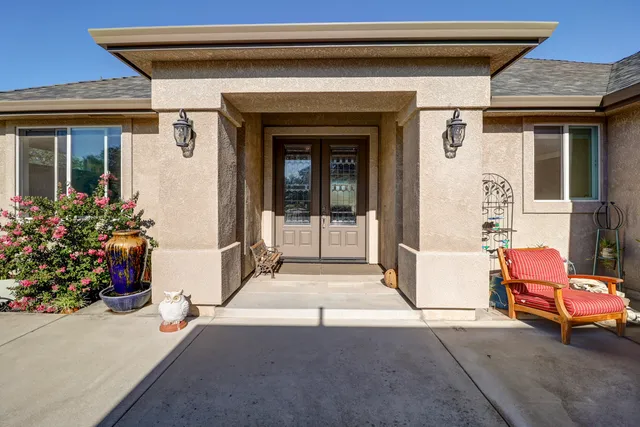 a front view of a house with outdoor seating