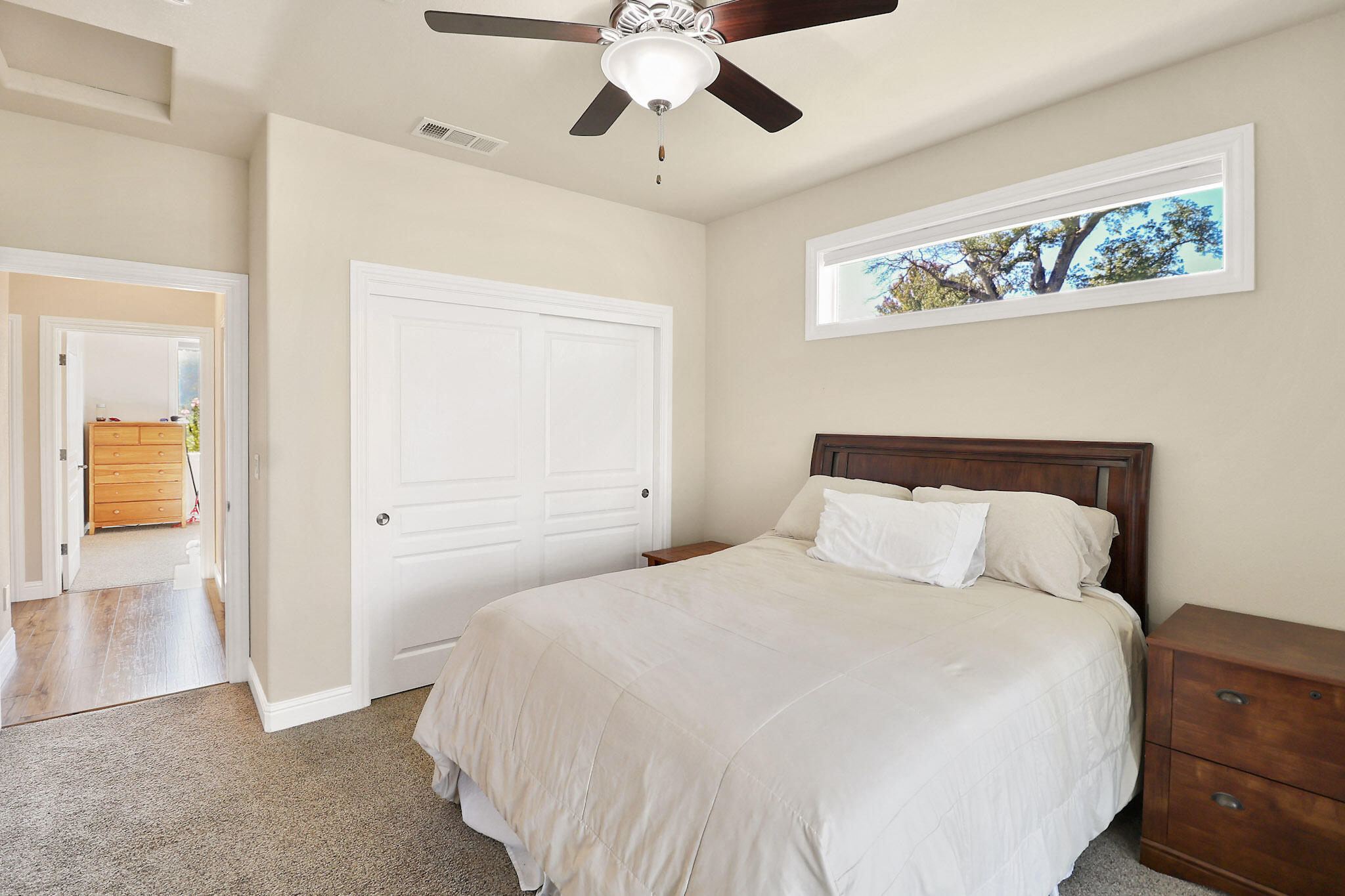 21089 Falling Leaf Road Redding, CA 96003 - Photo 16 of 43 a bedroom with a large bed and a chandelier