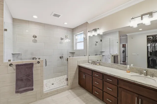 a spacious bathroom with a double vanity sink mirror double and shower
