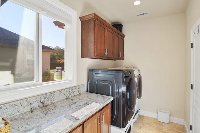 a kitchen with a sink a stove and a window