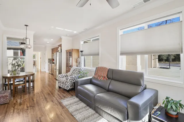 a living room with furniture and wooden floor