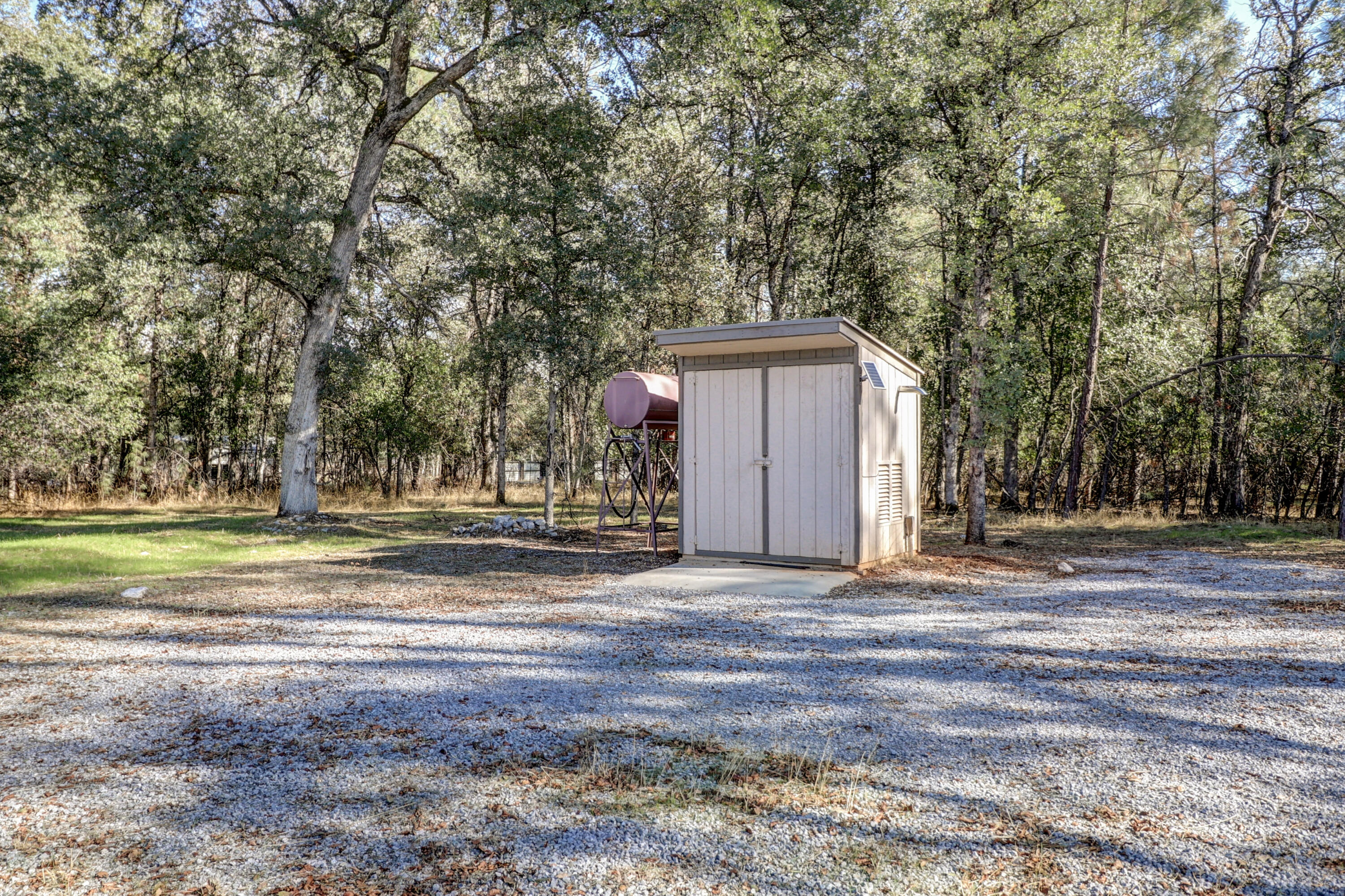 21089 Falling Leaf Road Redding, CA 96003 - Photo 36 of 43 a view of a house with backyard and trees