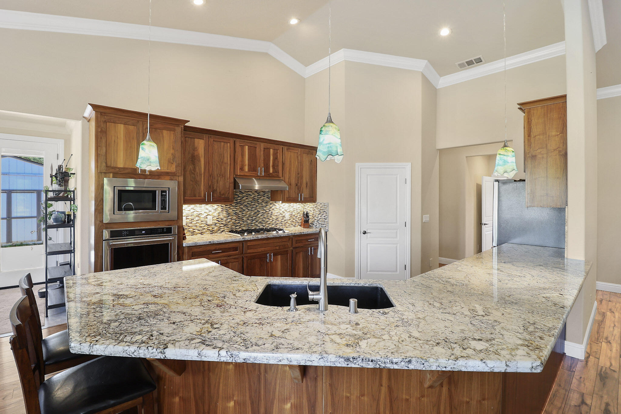21089 Falling Leaf Road Redding, CA 96003 - Photo 4 of 43 a kitchen with stainless steel appliances kitchen island granite countertop a refrigerator and stove