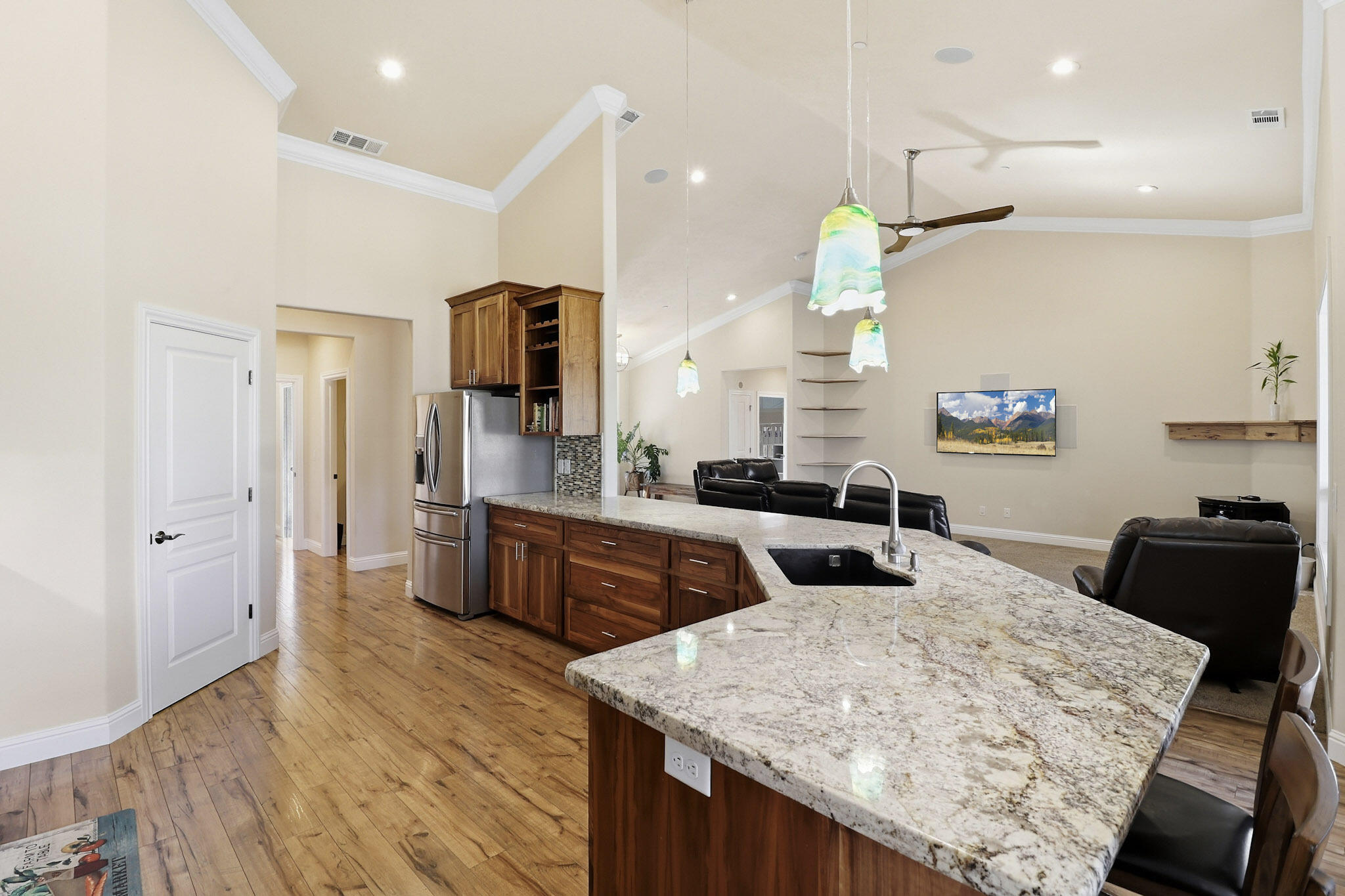 21089 Falling Leaf Road Redding, CA 96003 - Photo 10 of 43 a kitchen with stainless steel appliances granite countertop a table chairs refrigerator and microwave