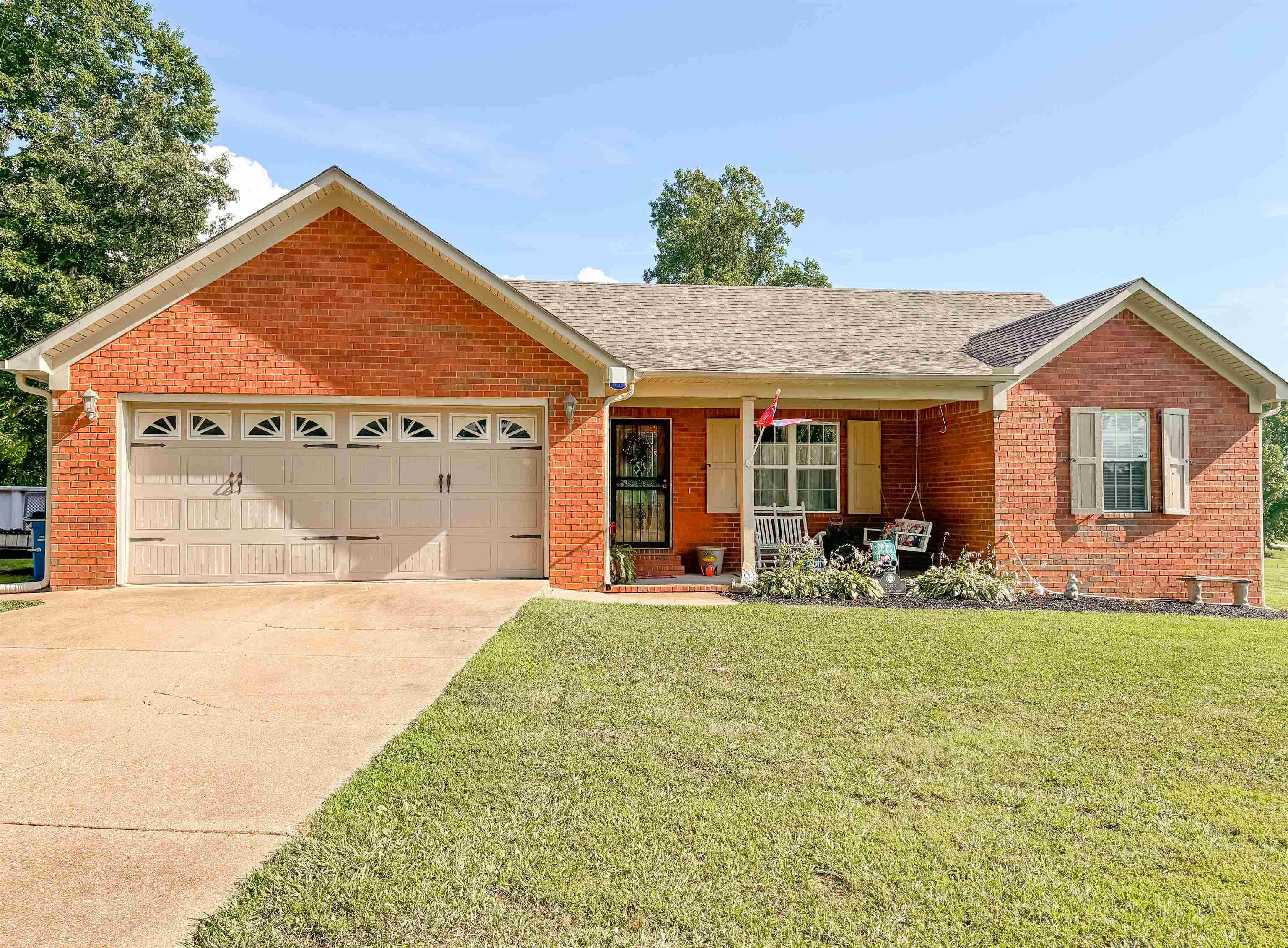 2933 Holly Grove Road Covington, TN 38019 - Photo 1 of 22 Ranch-style home featuring a garage and a front lawn