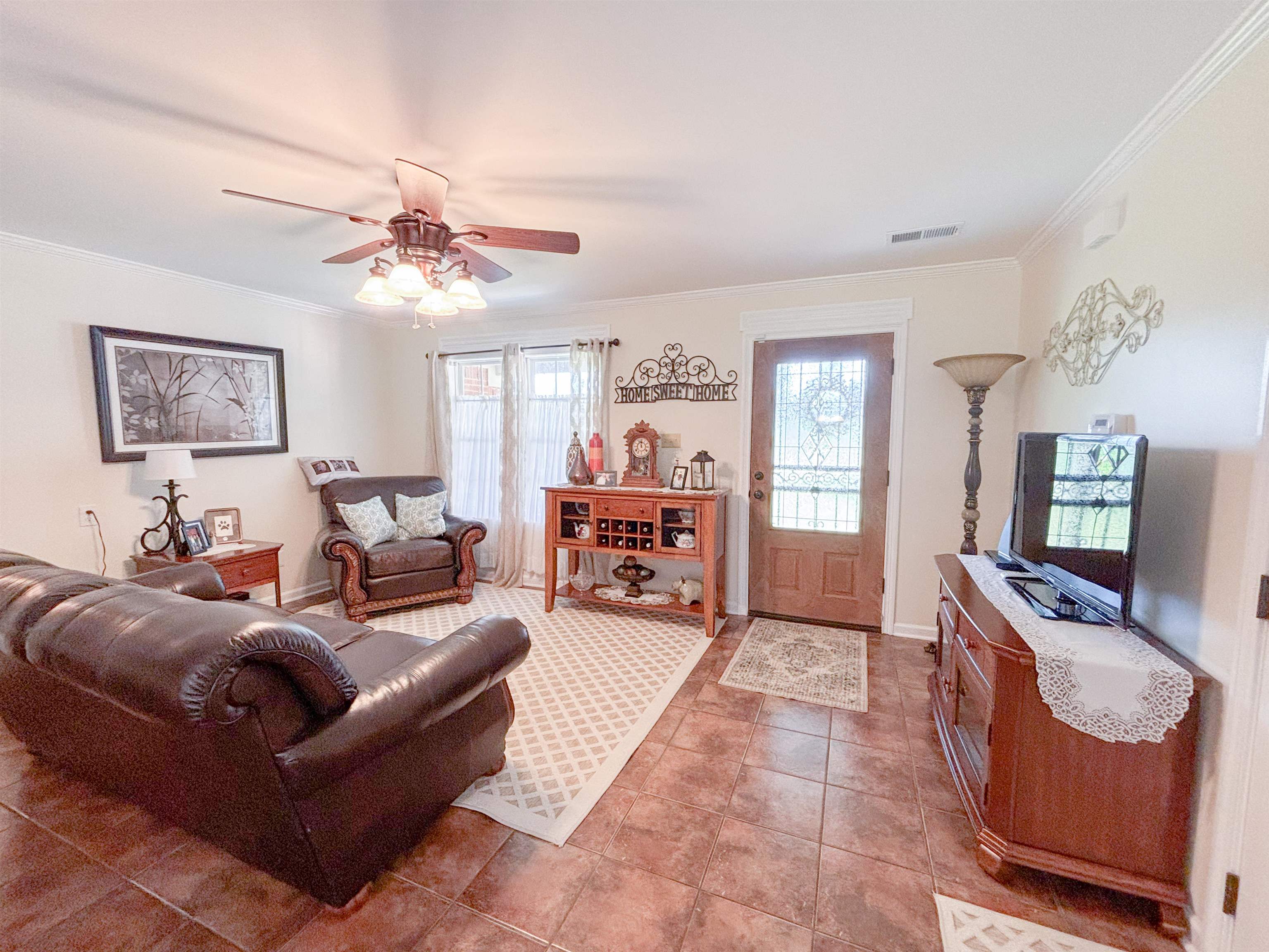 2933 Holly Grove Road Covington, TN 38019 - Photo 4 of 22 Tiled living room featuring ornamental molding and ceiling fan