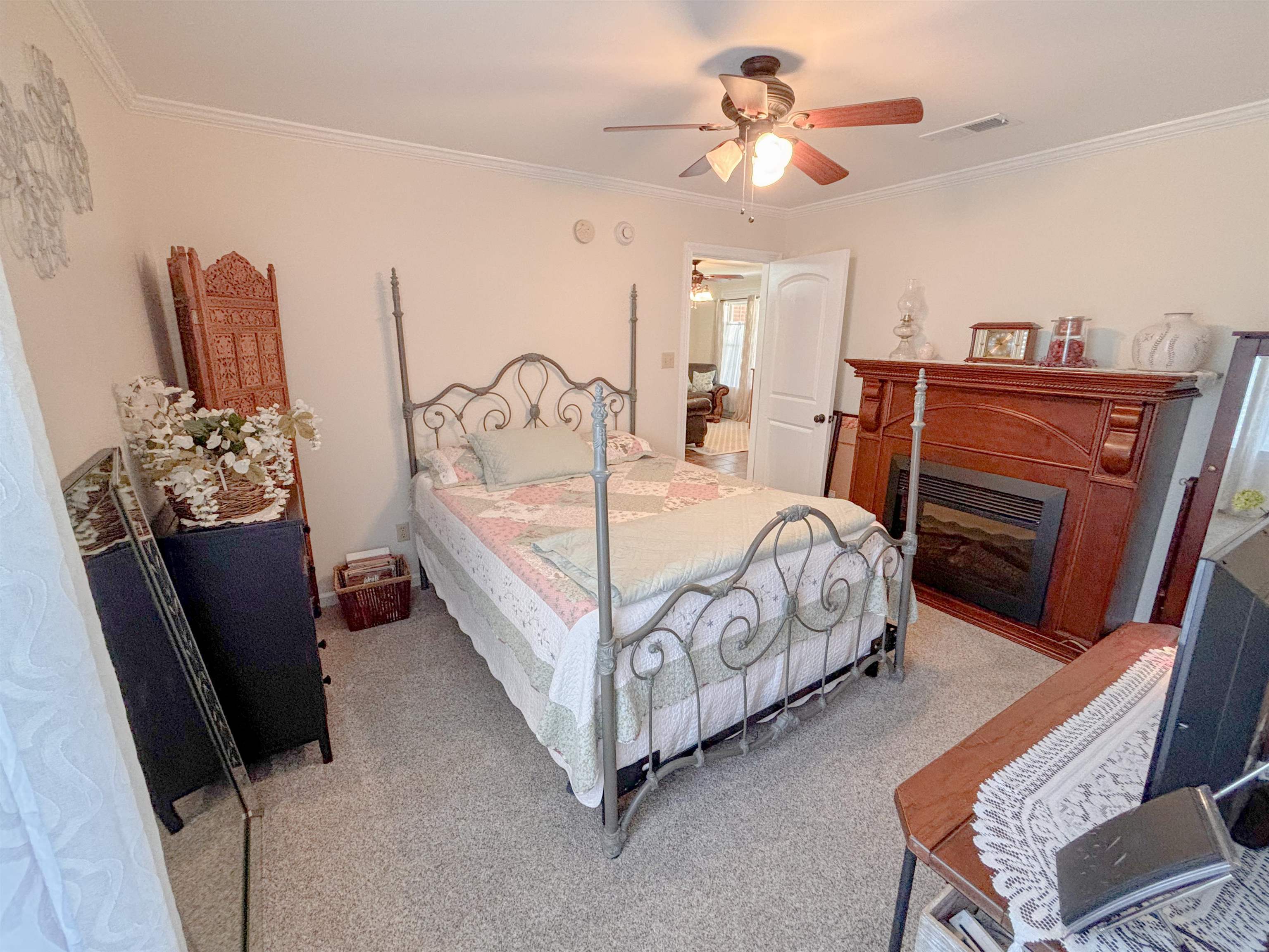 2933 Holly Grove Road Covington, TN 38019 - Photo 10 of 22 Carpeted bedroom featuring ceiling fan and ornamental molding