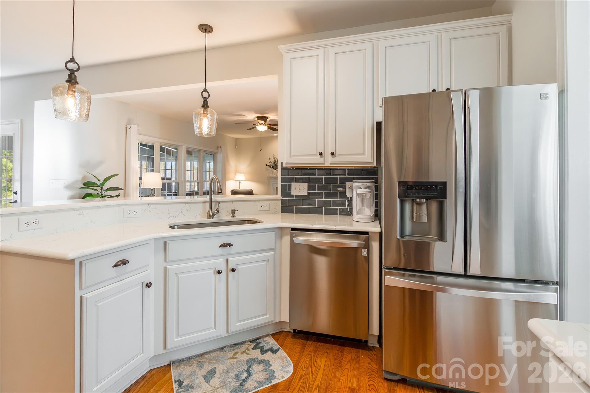 16800 Hampton Trace Road Huntersville, NC 28078 - Photo 13 of 48 a kitchen with stainless steel appliances a refrigerator sink and cabinets
