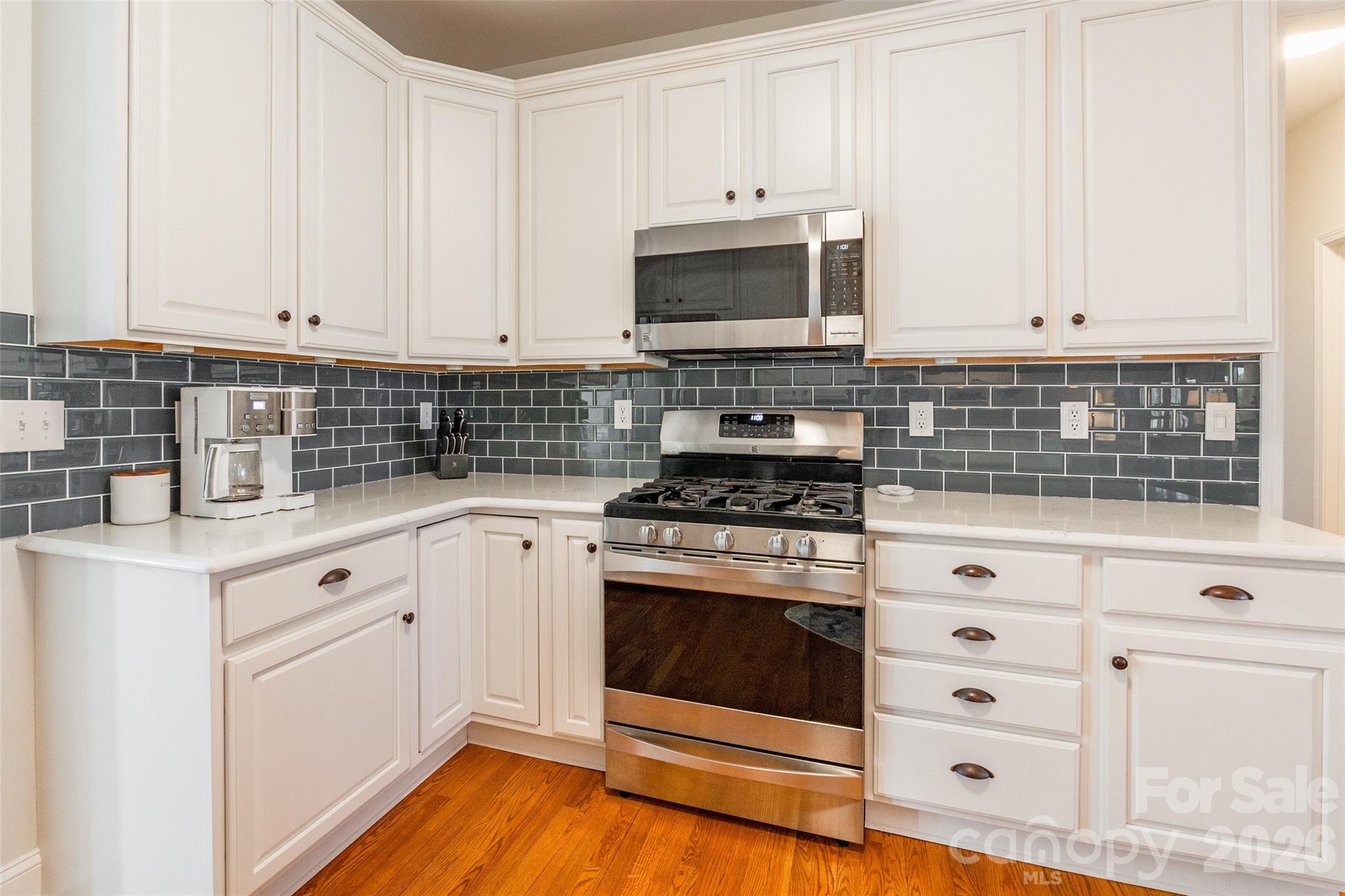 16800 Hampton Trace Road Huntersville, NC 28078 - Photo 14 of 48 a kitchen with white cabinets and appliances