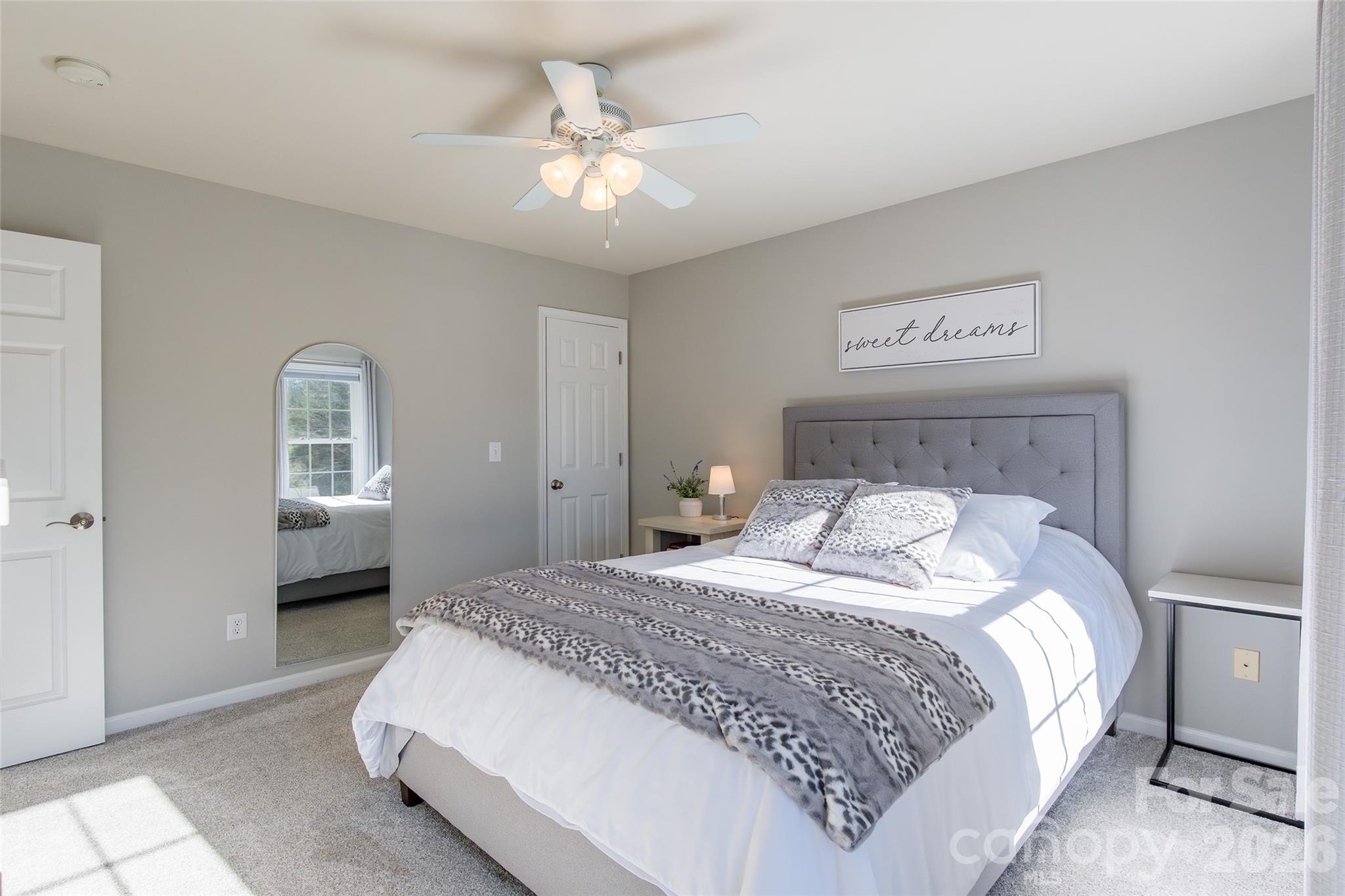 16800 Hampton Trace Road Huntersville, NC 28078 - Photo 28 of 48 a bedroom with a bed and a chandelier