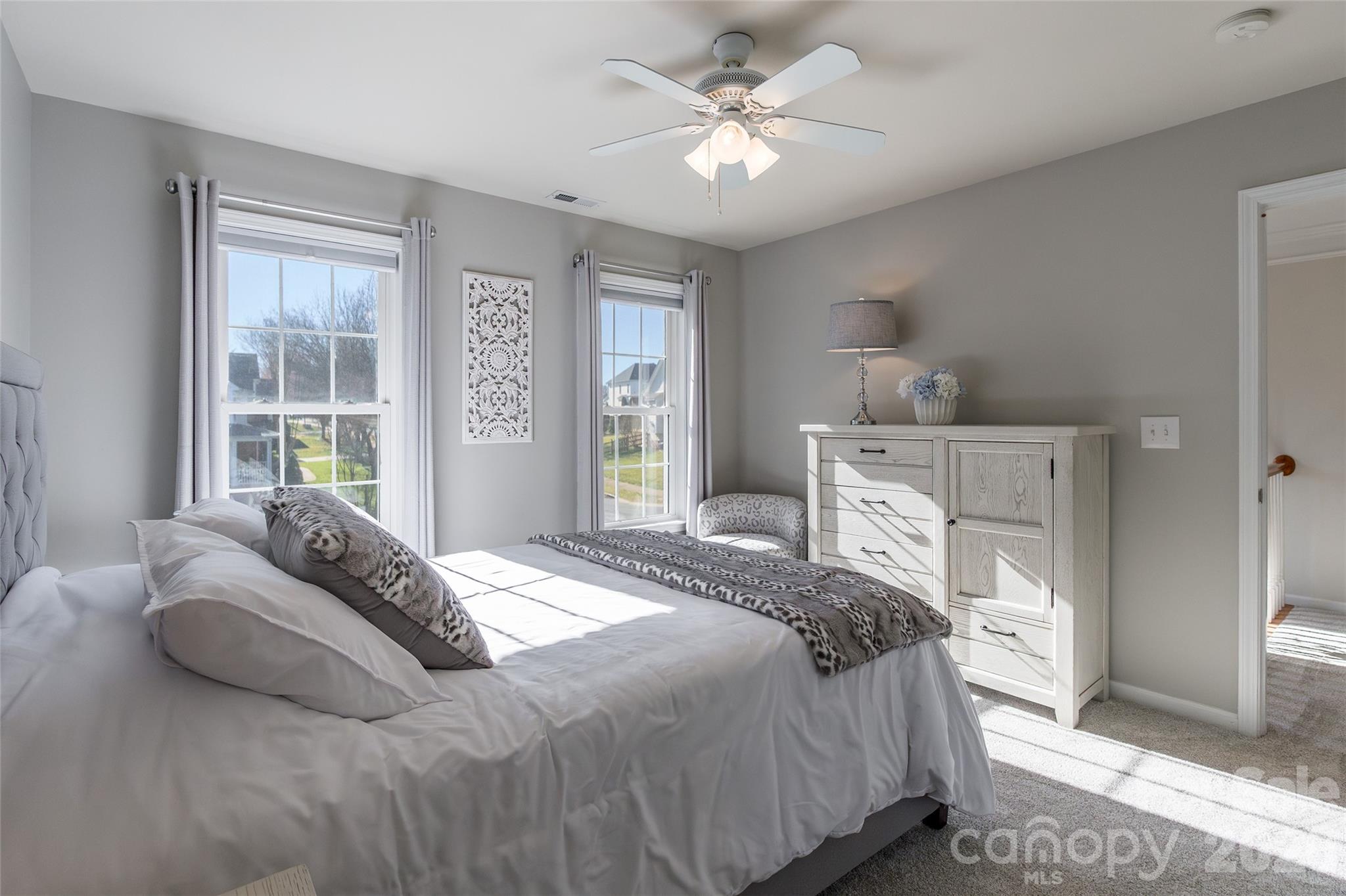 16800 Hampton Trace Road Huntersville, NC 28078 - Photo 29 of 48 a bedroom with a large bed and a chandelier
