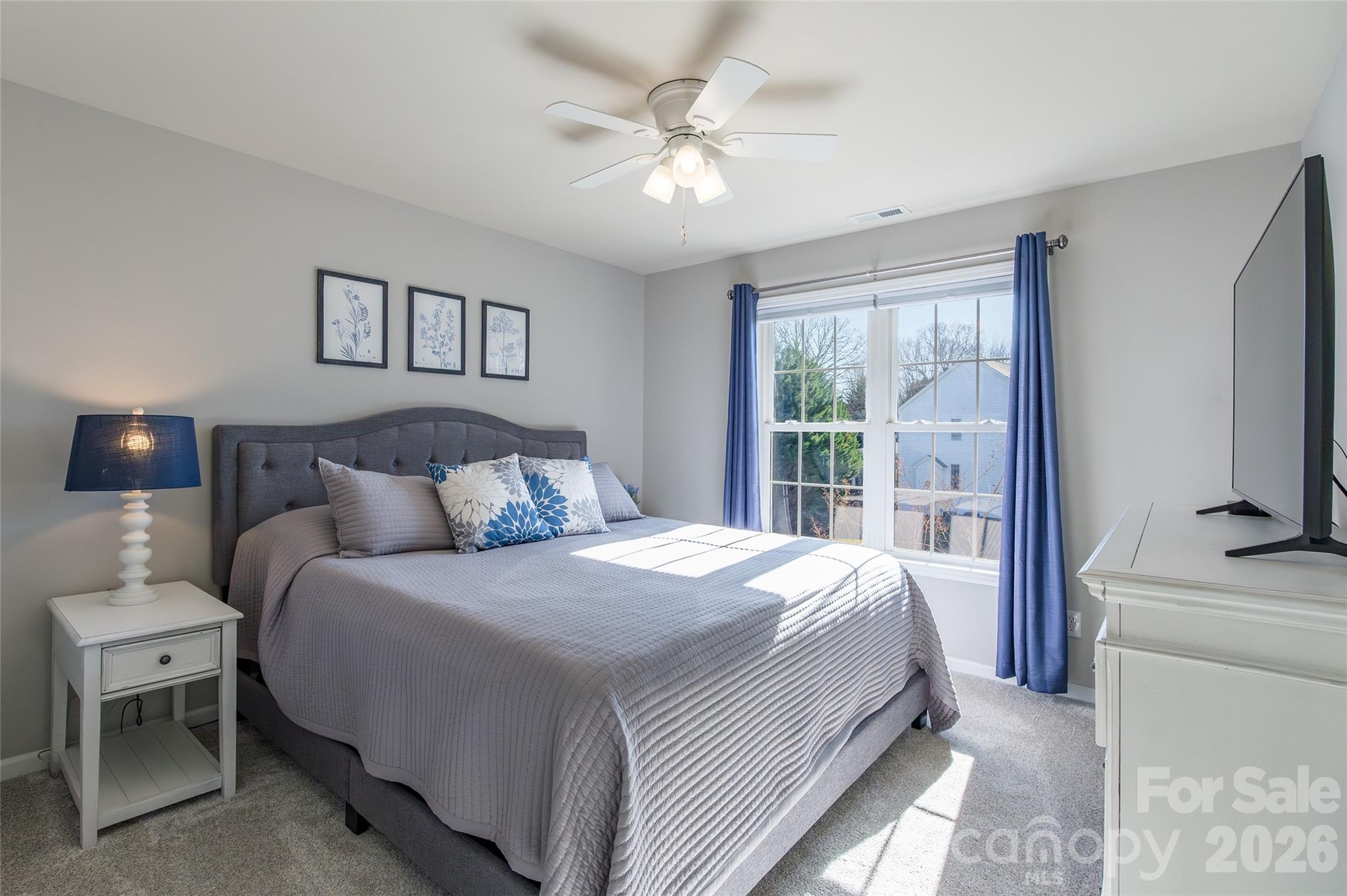 16800 Hampton Trace Road Huntersville, NC 28078 - Photo 30 of 48 a bedroom with a large bed and a tv