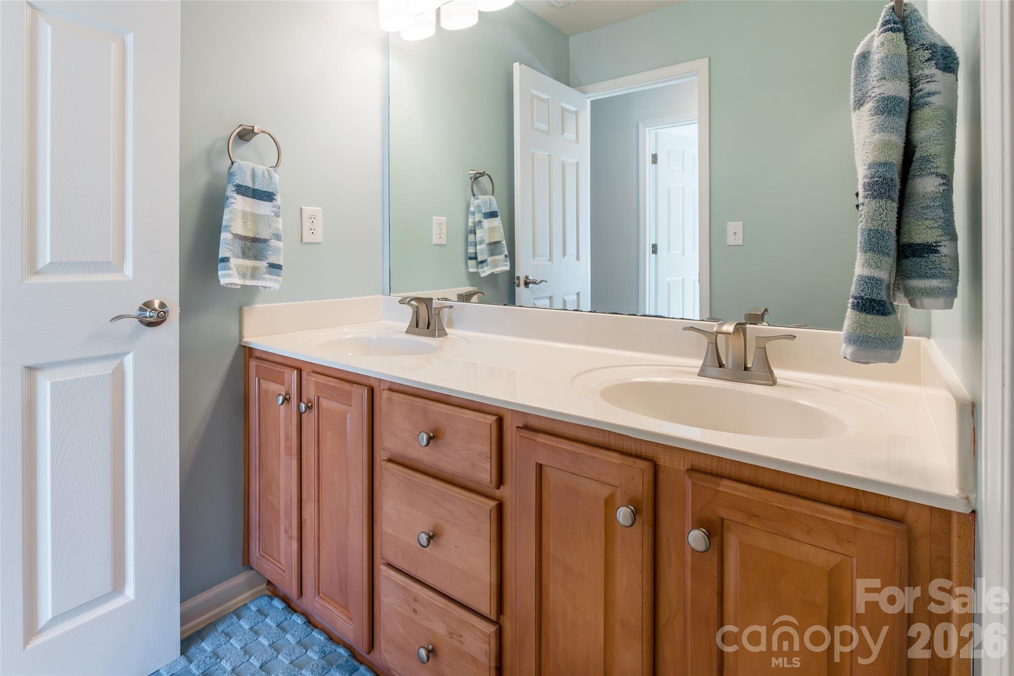 16800 Hampton Trace Road Huntersville, NC 28078 - Photo 32 of 48 a bathroom with a sink vanity and a mirror