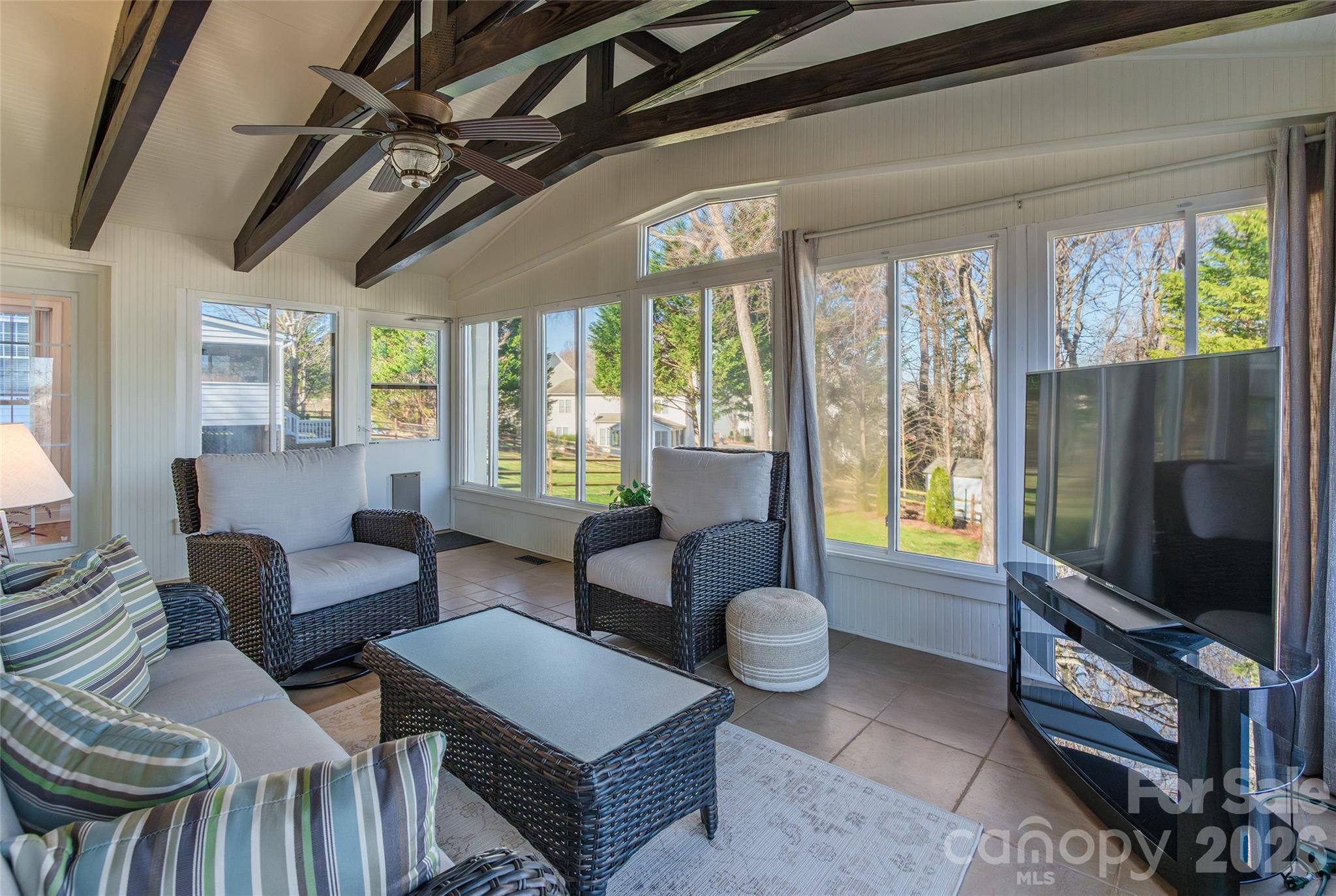 16800 Hampton Trace Road Huntersville, NC 28078 - Photo 40 of 48 a living room with furniture a flat screen tv and a floor to ceiling window