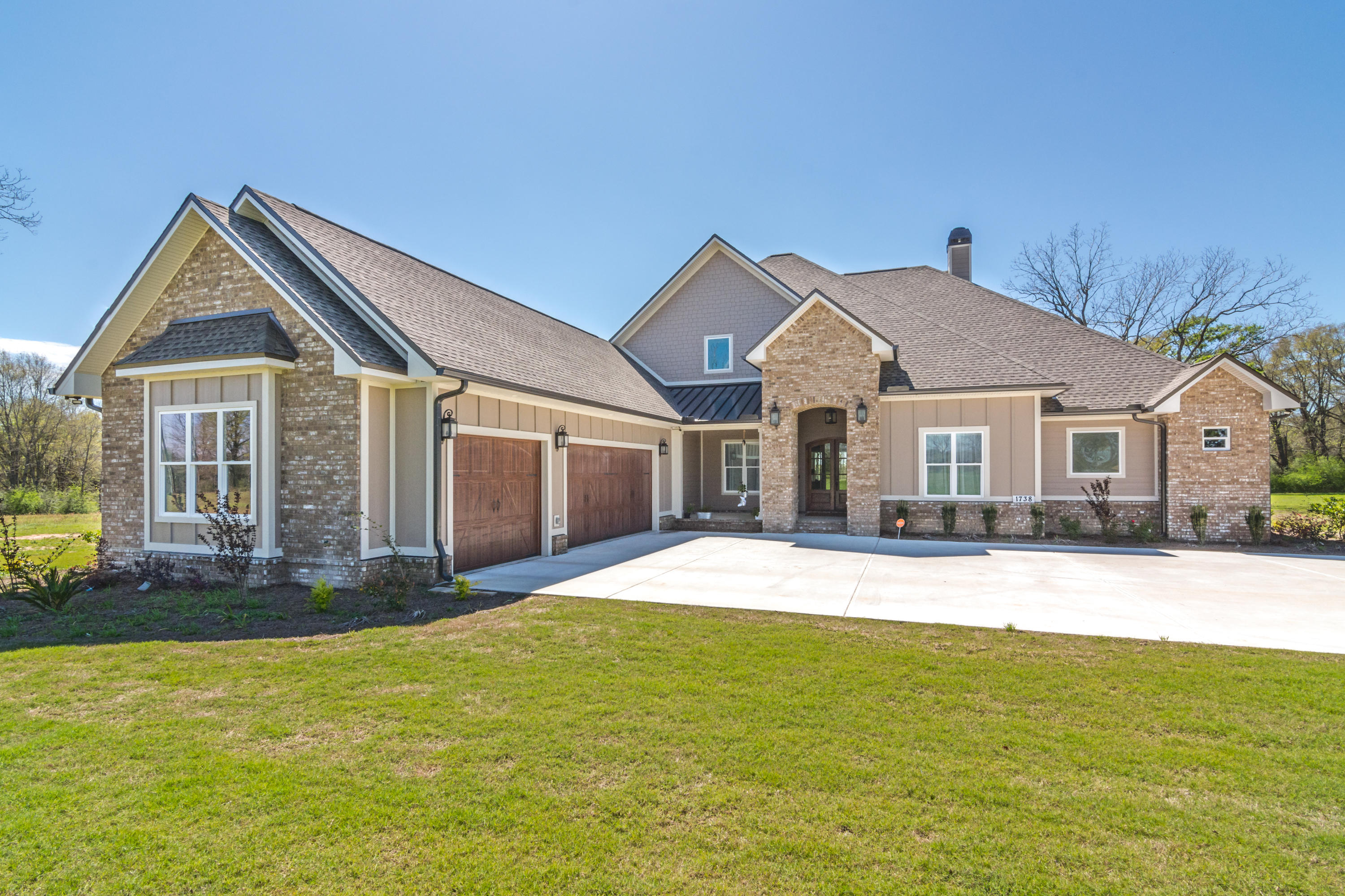 1738 Vinson Ray Road Baker, FL 32531 - Photo 1 of 50 a front view of a house with a garden