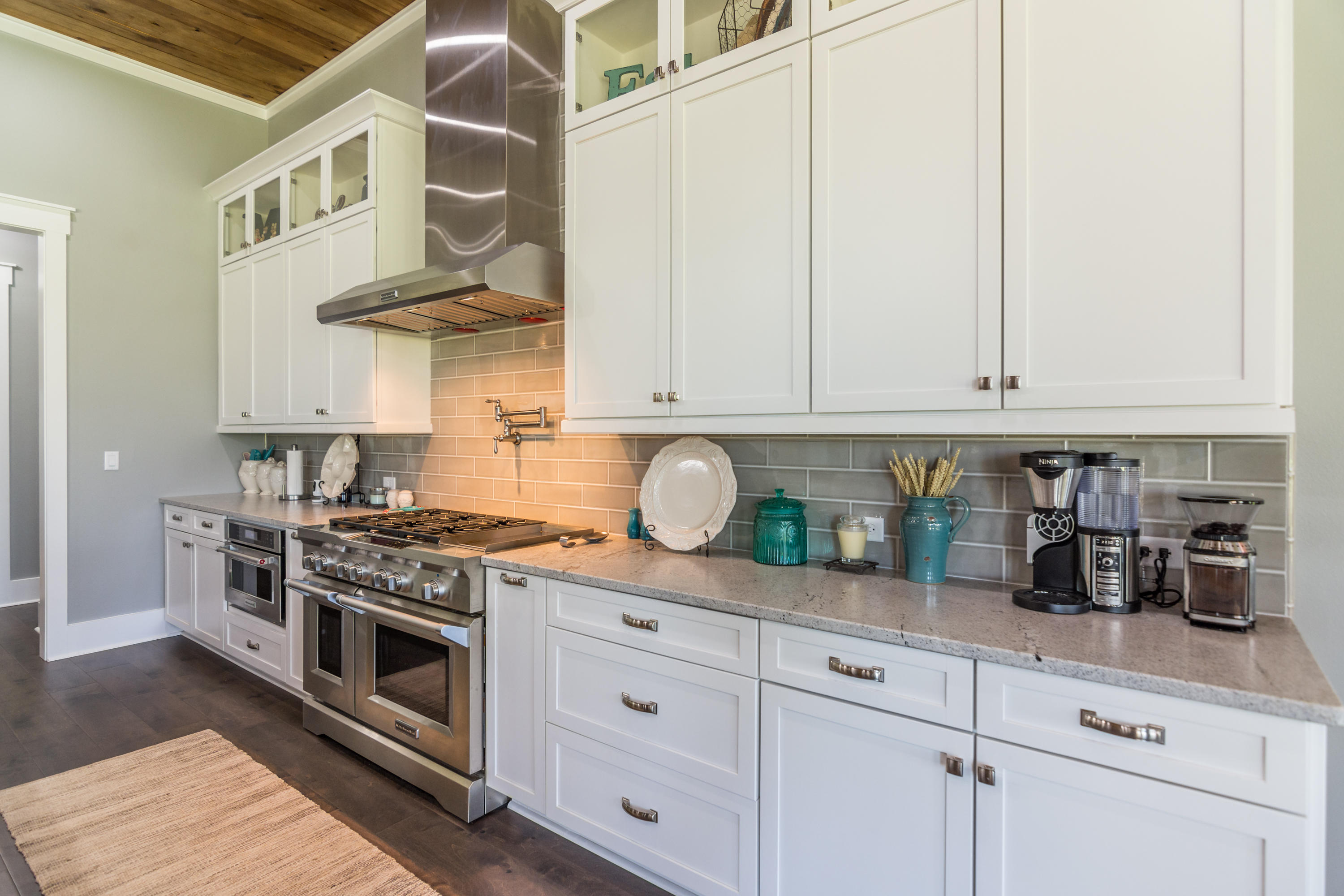 1738 Vinson Ray Road Baker, FL 32531 - Photo 13 of 50 a kitchen with stainless steel appliances granite countertop a stove and white cabinets