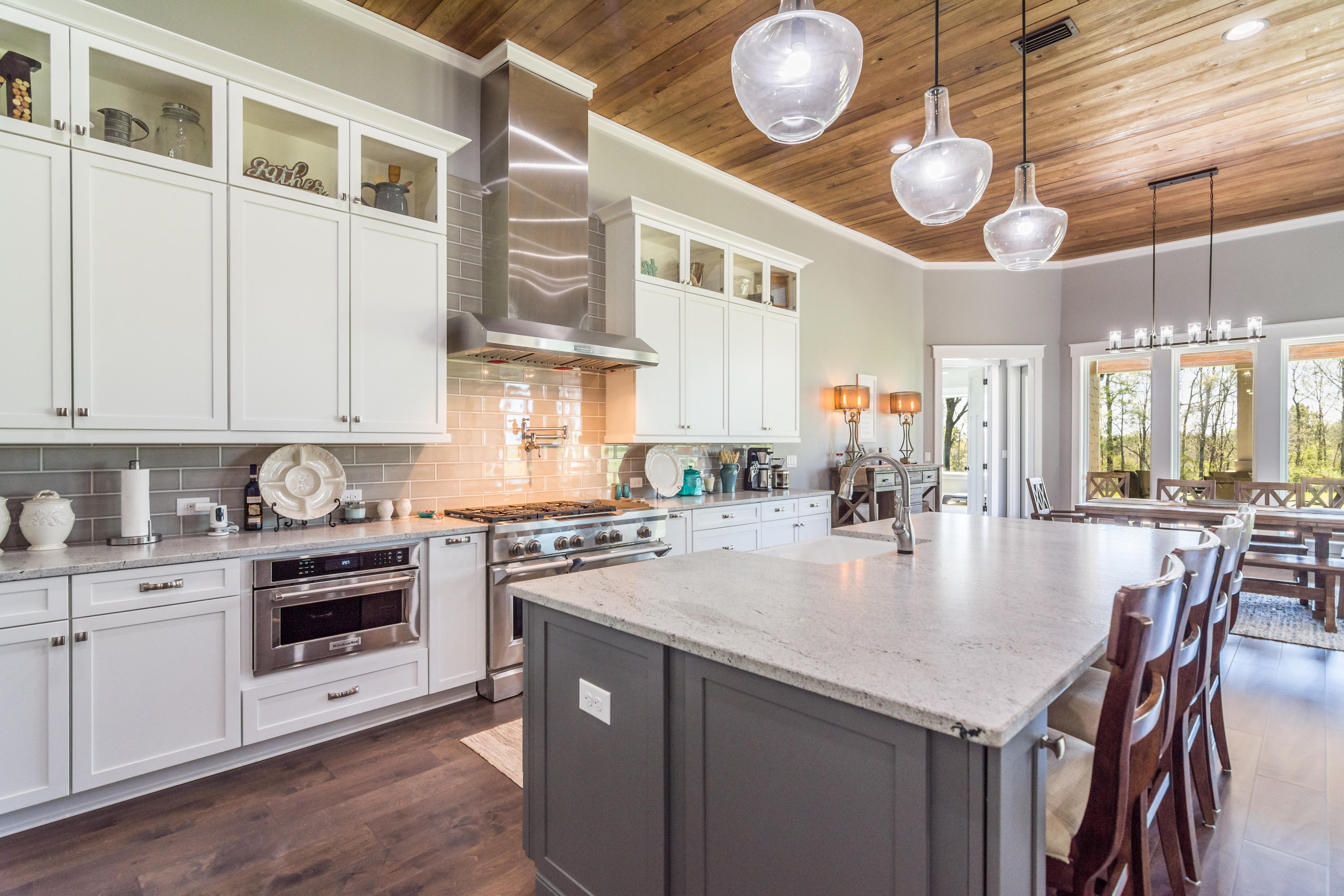 1738 Vinson Ray Road Baker, FL 32531 - Photo 15 of 50 a large kitchen with stainless steel appliances granite countertop a stove a sink a dining table and chairs with wooden floor