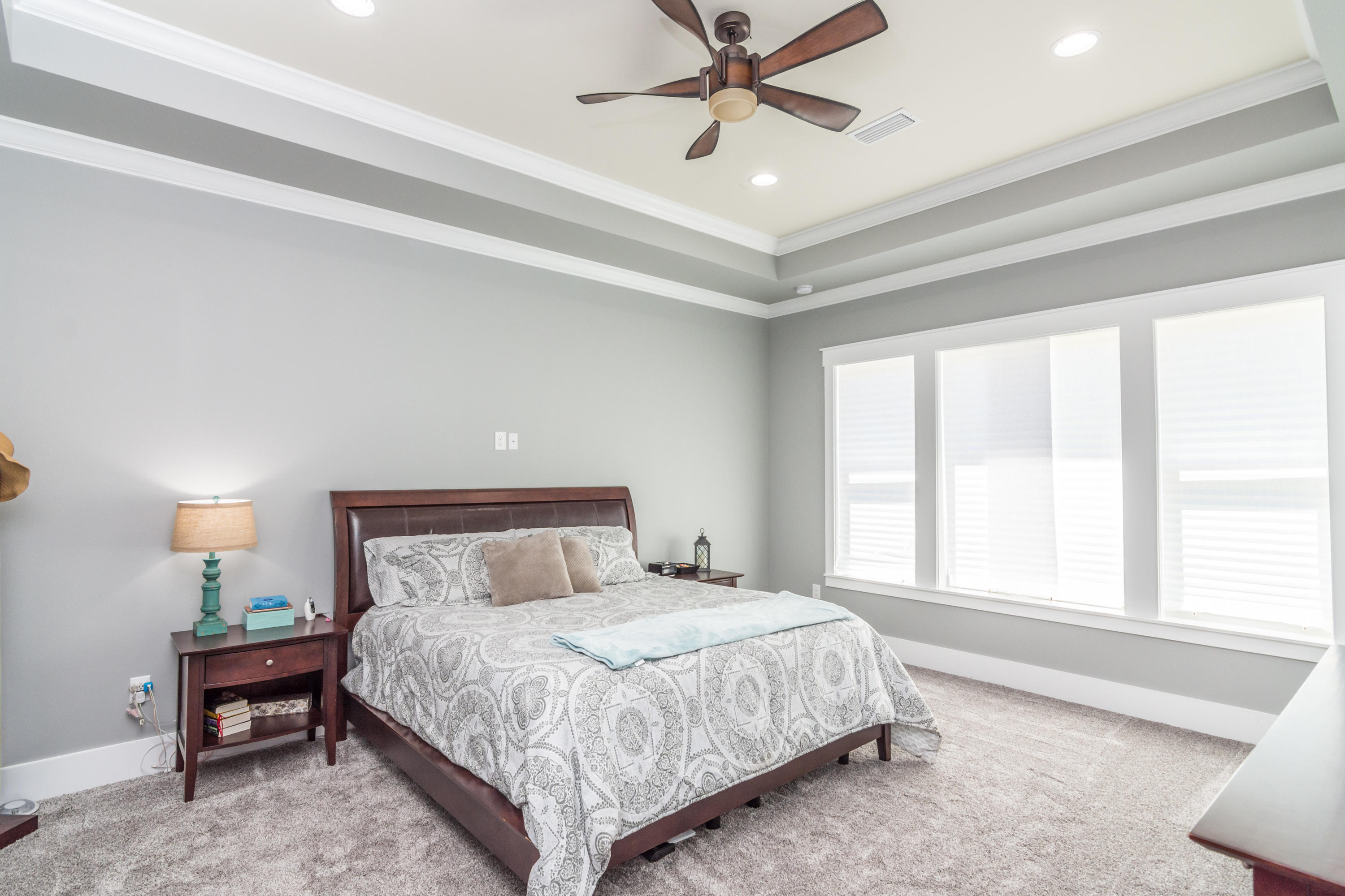 1738 Vinson Ray Road Baker, FL 32531 - Photo 20 of 50 a bedroom with a large bed and a chandelier