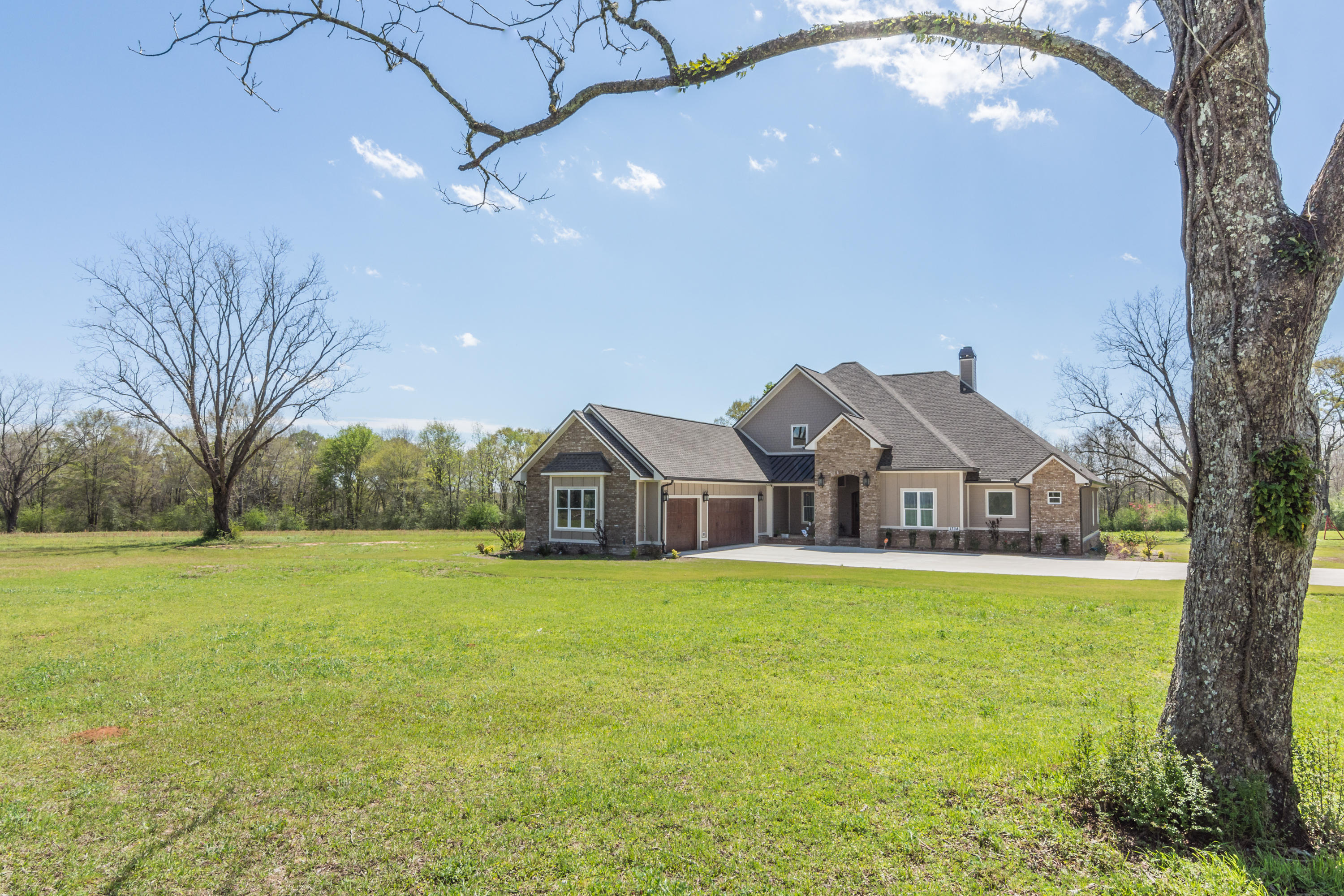 1738 Vinson Ray Road Baker, FL 32531 - Photo 36 of 50 a front view of a house with a yard and large trees