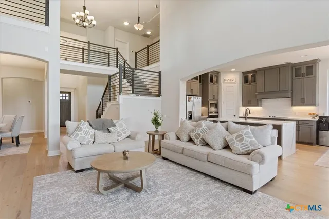 a living room with furniture and kitchen view