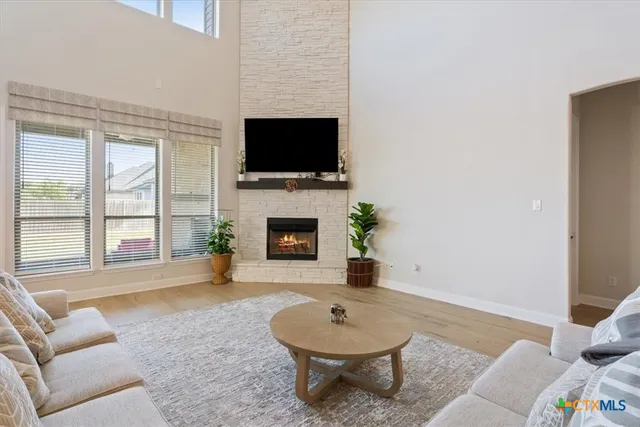 a living room with furniture a flat screen tv and a fireplace