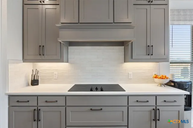 a kitchen with white cabinets and a sink