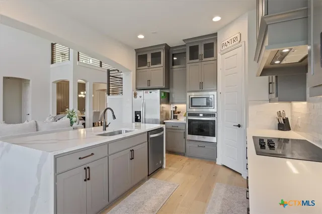 a kitchen with stainless steel appliances granite countertop a sink and cabinets