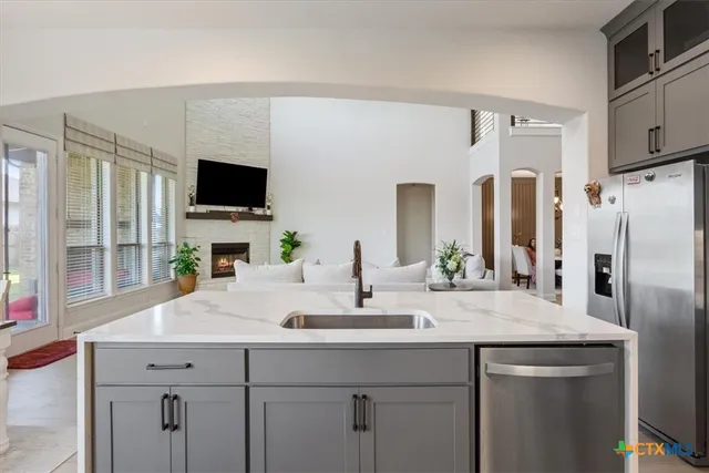 a kitchen with stainless steel appliances a sink and a refrigerator