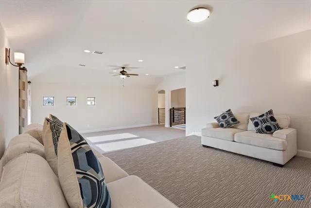 a bedroom with a bed a dresser and next to a window