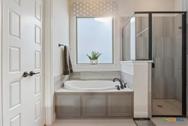 a bathroom with a bathtub and a sink