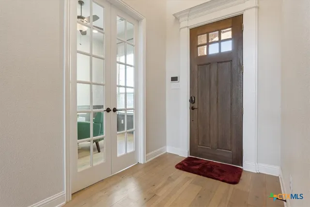 a view of front door with wooden floor