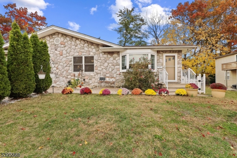 a backyard of a house with table and chairs and potted plants