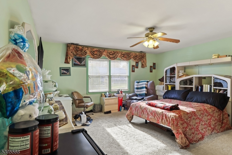 32 Ruby Street Springfield, NJ 07081 - Photo 12 of 31 a bedroom with a bed gym equipment and a large window
