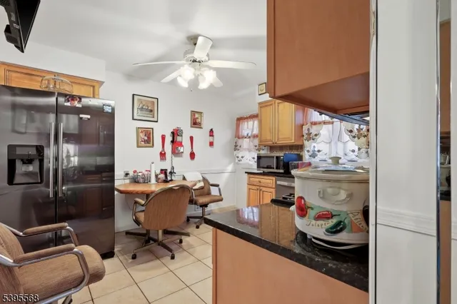 a kitchen with a refrigerator and furniture
