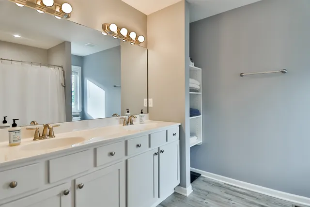 a bathroom with a double vanity sink and a mirror