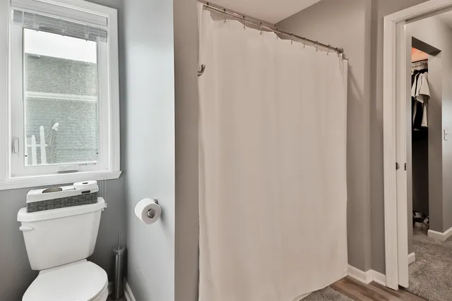 a white toilet sitting next to a bathroom sink
