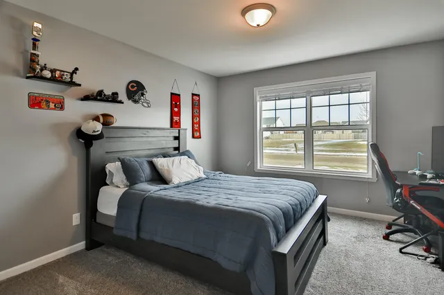 a bedroom with a bed and a large window