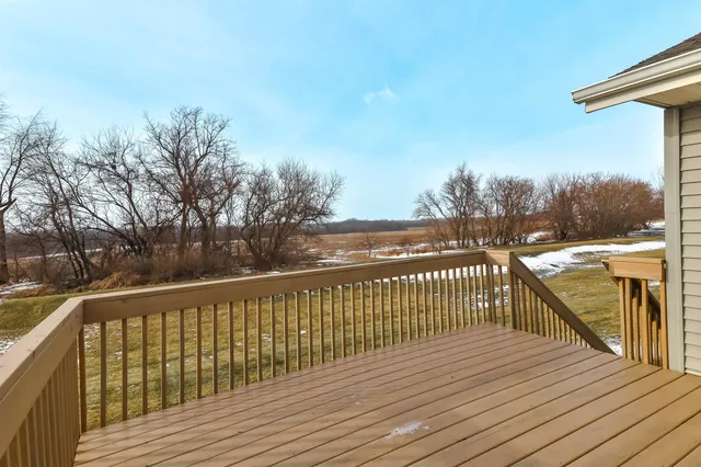 a view of balcony with wooden floor and fence