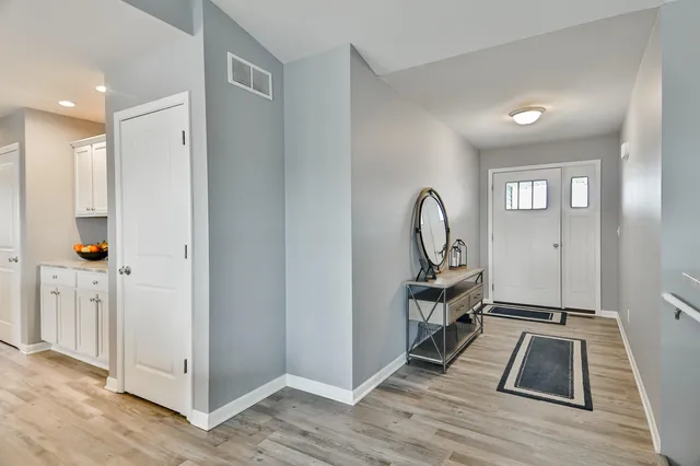 a view of a room with wooden floor and furniture