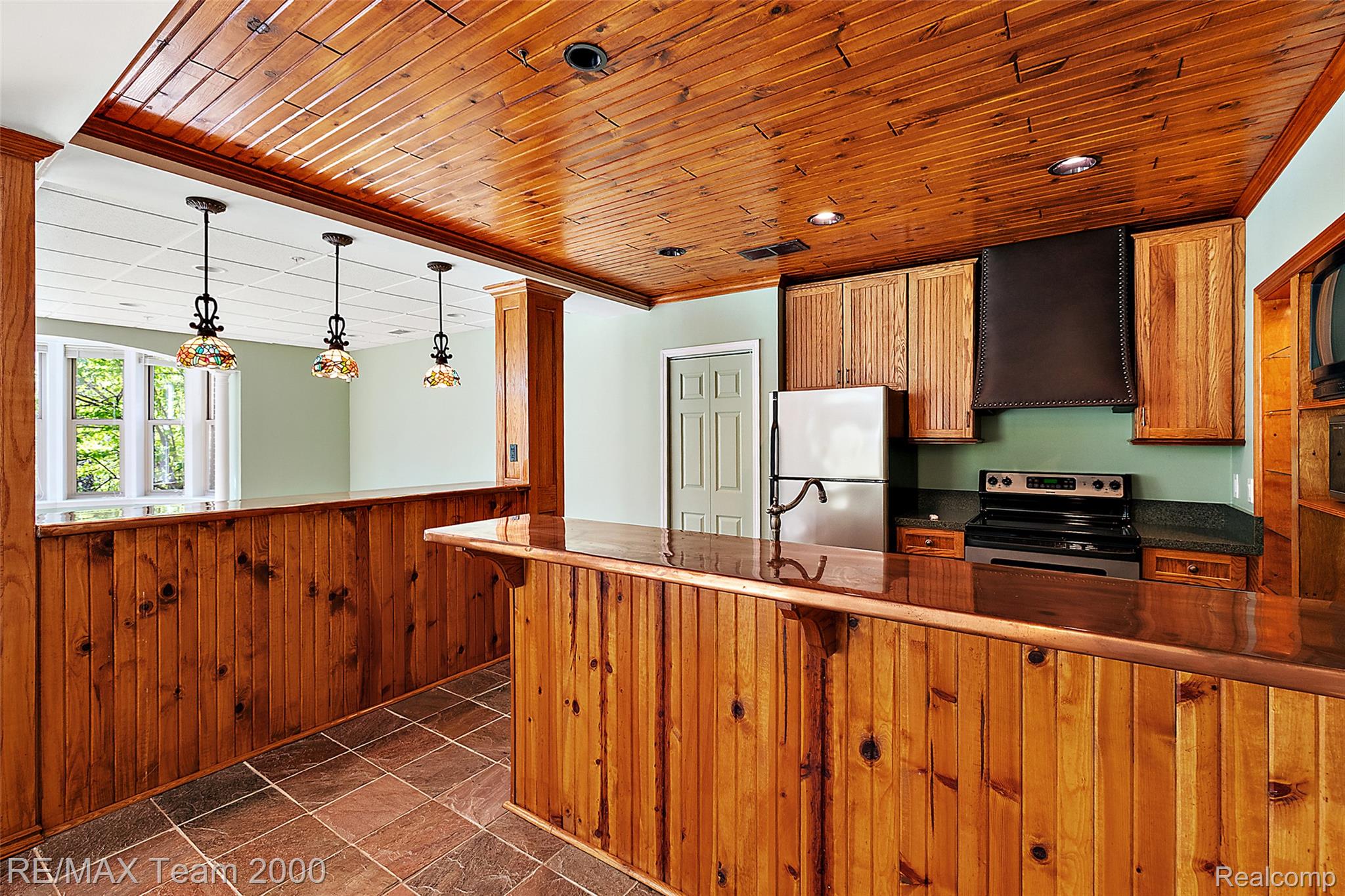 630 Sheldon Court Rochester, MI 48306 - Photo 73 of 94 Kitchen with wooden walls, wainscoting, range hood, wood finish cabinets, and stainless steel appliances