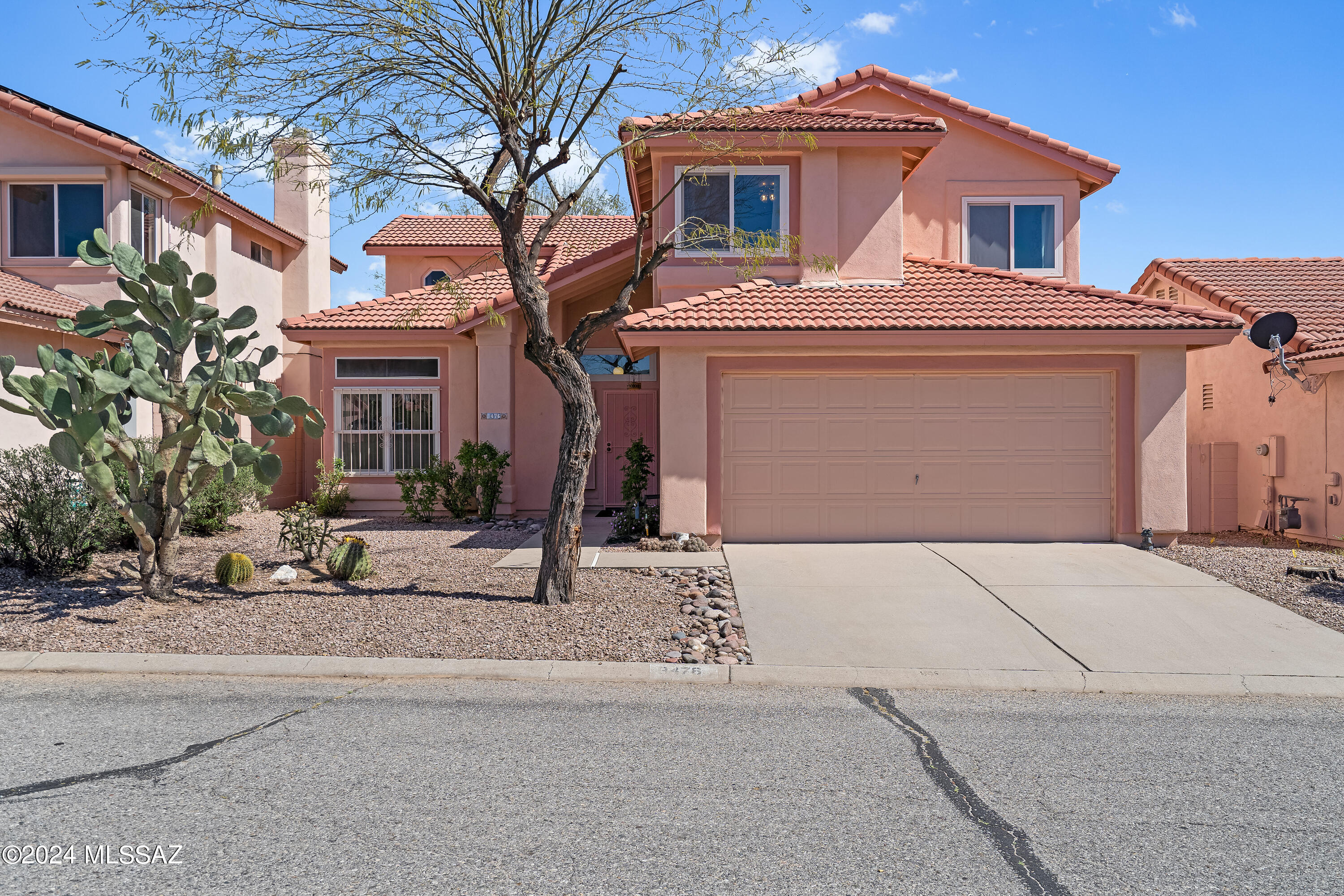 3476 West Sky Ridge Loop Tucson, AZ 85742 - Photo 2 of 31 a front view of a house with a yard and garage