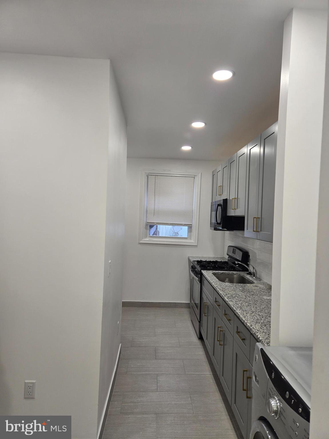 3513 Vista Street Philadelphia, PA 19136 - Photo 6 of 10 a kitchen with stainless steel appliances a sink and a stove top oven