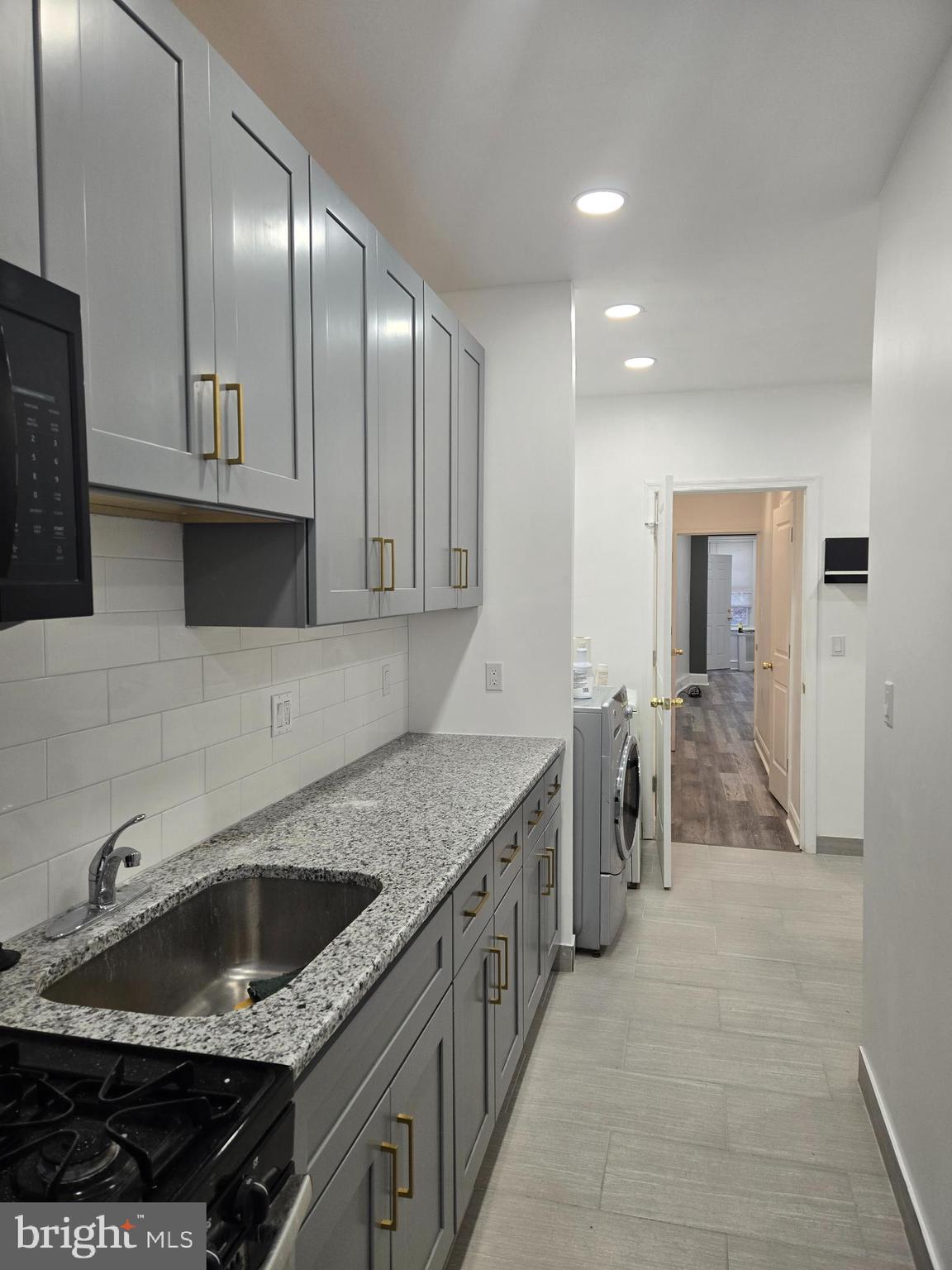 3513 Vista Street Philadelphia, PA 19136 - Photo 7 of 10 a kitchen with stainless steel appliances granite countertop a sink stove and cabinets