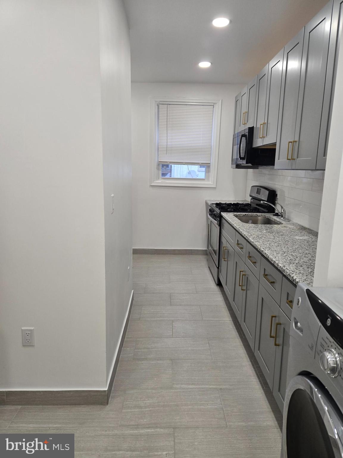 3513 Vista Street Philadelphia, PA 19136 - Photo 8 of 10 a kitchen with stainless steel appliances granite countertop a stove and a sink