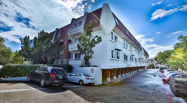 a view of a car park in front of house