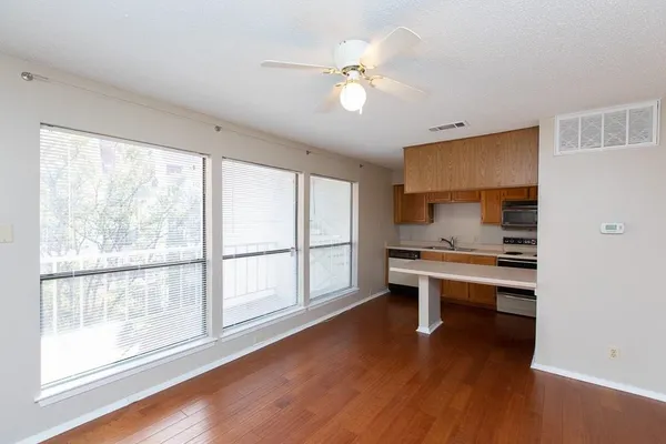 a view of work space with wooden floor and windows